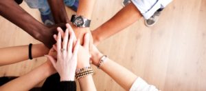 Group of people stacking hands